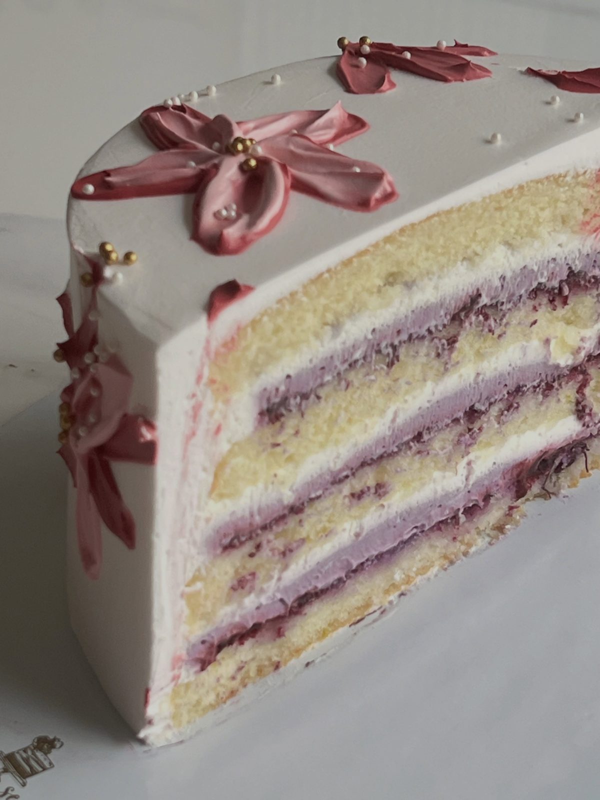 Burgundy bloom cake sliced to show lemon blueberry layers